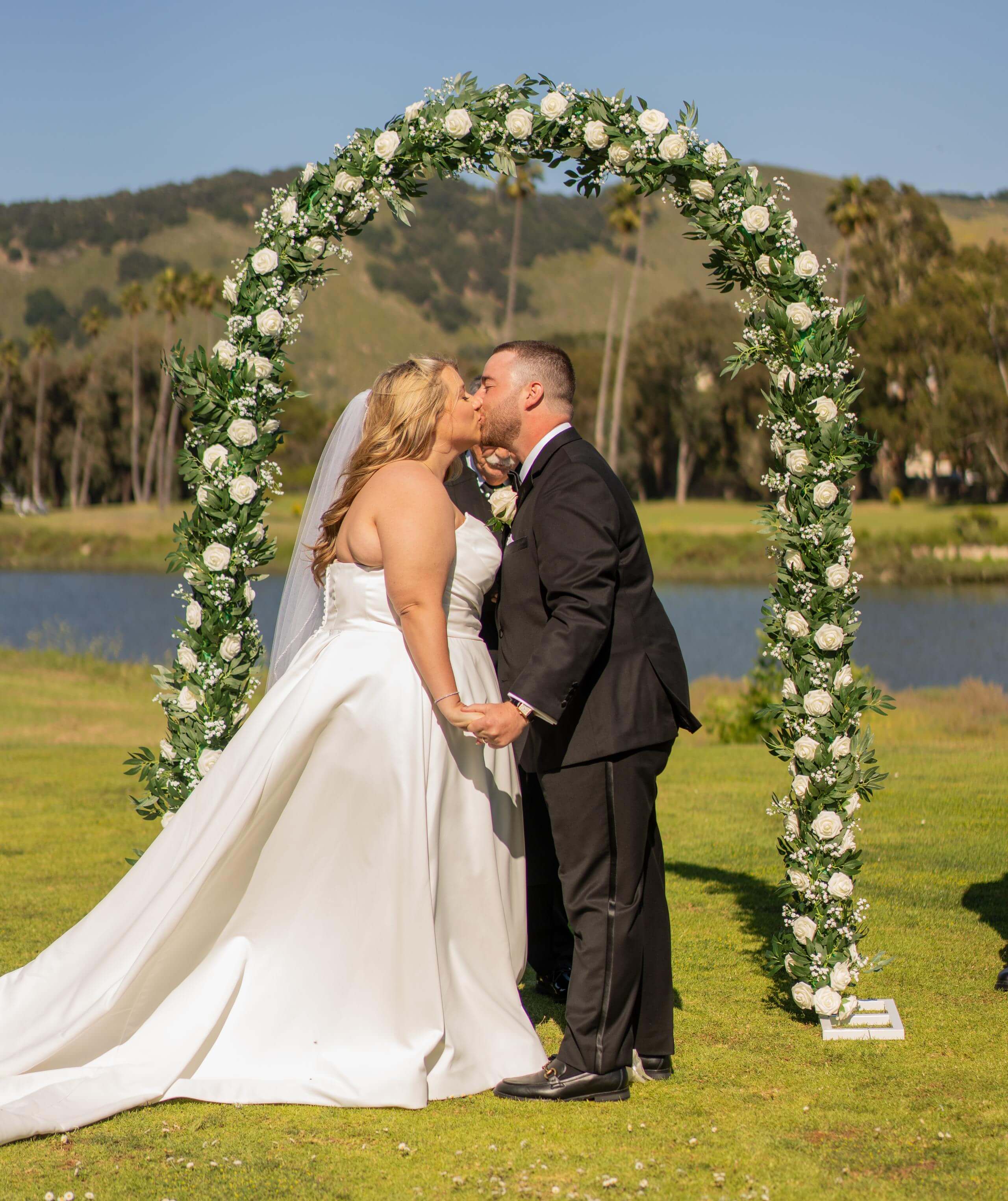 timeless-images-california-wedd...uple-kissing-ceremony-arch.jpg