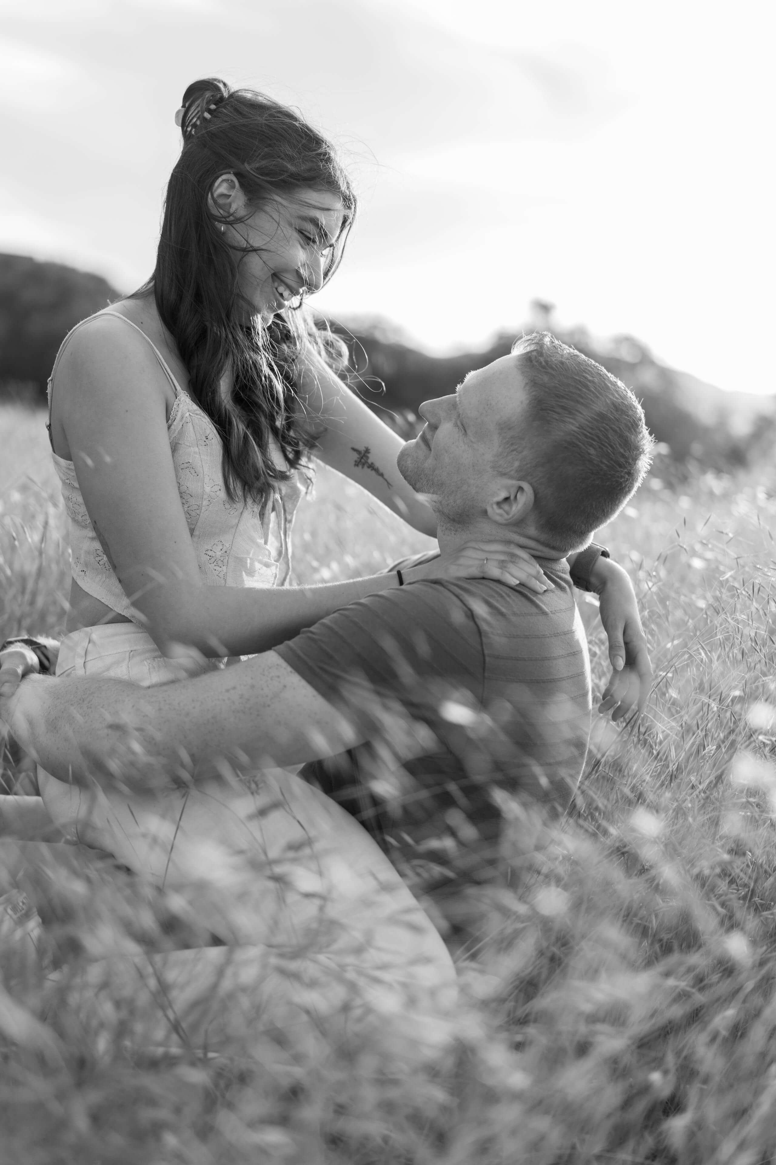 couple-embrace-laughter-field-black-white-timeless-images.jpg